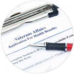 Pen lying on top of an application form for veterans benefits